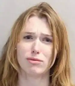 A headshot of a tearful Rheintgen against a gray background