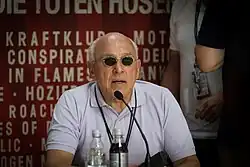 Marek Lieberberg sits and speaks into a microphone