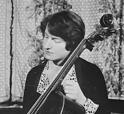 A white woman playing a cello