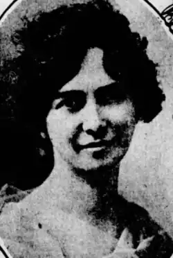 A smiling white woman with dark hair
