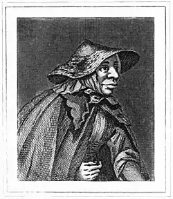 A half-length monochrome portrait of an elderly woman. She wears a wide-brimmed hat, and has a large nose and well-fleshed mouth