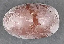 Small egg-shaped chocolate confection with a thin, noticeably white coating
