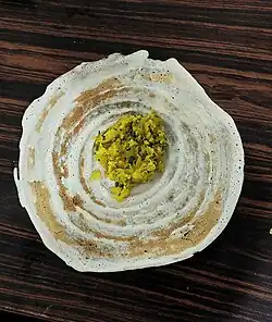 Masala dosa before folding, showing the potato curry filling