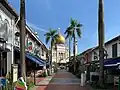 The mosque's walking street from Bussorah Street.
