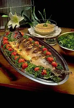 Image 32Masghouf fish, one of Iraq's national dishes, a Mesopotamian cuisine dating back to ancient times, typically fish caught from the rivers of Euphrates and Tigris, and grilled near the river bed (from Culture of Iraq)