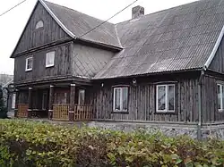 A surviving timber framed Olender house with portico, constructed in 1837