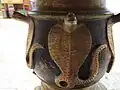Serpant art on the peacock-faced lamp in front of the Valampuri Vinayakar