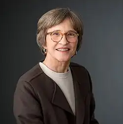 Headshot of Mayree Clark, a white woman with short brown hair and glasses