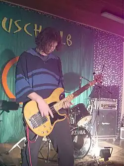 Photo of bassist in grunge attire, 2001