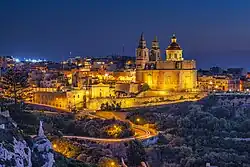 Mellieħa village core at night, prominently featuring the parish church
