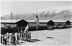 Memorial Day services at Manzanar Camp in 1942 with Boy Scouts performing the flag ceremony