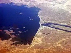 Image 40Merowe Dam in Sudan. Hydroelectric power stations that use dams submerge large areas of land due to the requirement of a reservoir. These changes to land color or albedo, alongside certain projects that concurrently submerge rainforests, can in these specific cases result in the global warming impact, or equivalent life-cycle greenhouse gases of hydroelectricity projects, to potentially exceed that of coal power stations. (from Hydroelectricity)