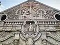 Façade and pediment detail featuring St. Thomas of Villanova (lower) and St. Christopher carrying the child Jesus on his back (upper)