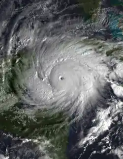 Satellite image of Hurricane Michelle east of the Yucatan Peninsula. It is displaying a clear eye surrounded by large rainbands.