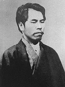 Black and white photograph of a man wearing a kimono