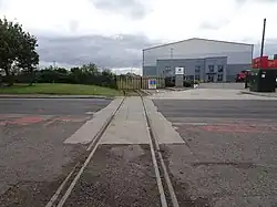 The site of the first timber-built station, opened in 1830 by the Stockton & Darlington Railway; it is now an industrial estate