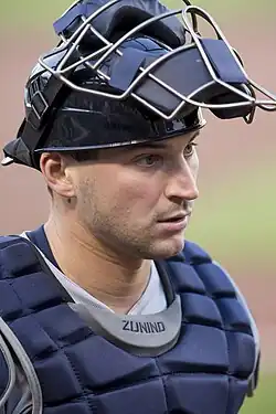 Mike Zunino, wearing blue catching gear with his mask up