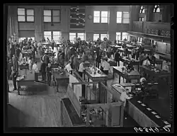 several dozen men inside the grain exchange with two stories of windows