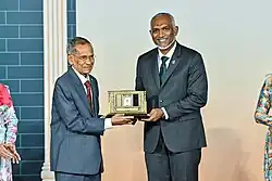 Mohamed Zahir Hussain receiving the Highest Honour of Service to the Education Sector by President Mohamed Muizzu