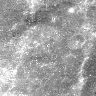 Molière crater at a high sun angle. The crater is barely distinguishable due to lack of shadows. The southern rim is in the lower left corner.
