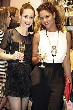 Image 83Two women in Brazil wearing monochromatic evening outfits with sheer elements and streamlined silhouettes, 2014. (from 2010s in fashion)