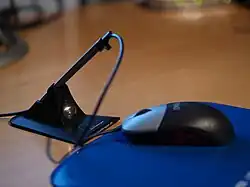 computer mouse on a mouse pad, the cable being held by a mouse bungee