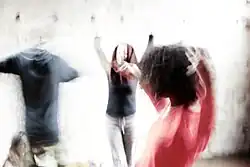 Several people moving with their eyes closed, listening to their own sensations