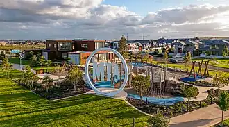 Mt A. welcome sign with pocket park and the Vision Centre in the background