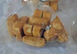 Typical muéganos, prepared and wrapped, being sold in a market in Huamantla, Tlaxcala.