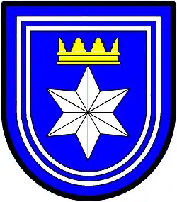 a double tressure—Azure; a facetted six pointed star [mullet] argent ensigned with a gable crown or, the whole within a double tressure argent—Langenhoven, RSA