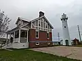 The lighthouse (right) with the former house of the keeper on the left. The house is now a private residence.