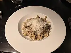 A minced Mushroom Strozzapreti in a white dish.