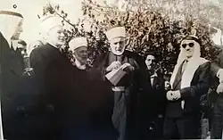 Sheikh Muhammad Ali al-Ja’abari, mayor of the city of Hebron, and to his left is Sheikh Mustafa bin Abdul Halim Tahboub al-Marwani, the Qadi of Hebron. Next to him is Sheikh Abdul Hayy Arfa, the Mufti of Hebron. Next to him is Ahmed al-Shuwaiki al-Rifai, in the city of Hebron. To the right of Sheikh Muhammad Ali is Hamdi Sultan al-Tamimi, one of the notables of Hebron