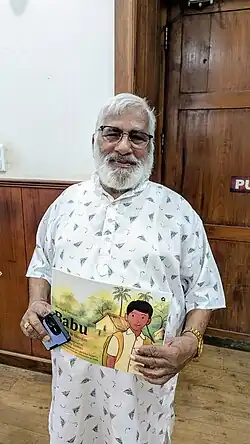 N. Shivdas with his book, Babu, in 2025