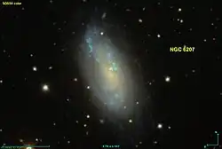 NGC 6207, clearly displayed and labeled, with visible surface features such as tightly wounded spiral arms.