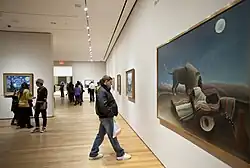 People viewing paintings in a gallery at the Museum of Modern Art, New York City.