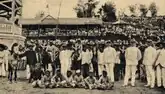 Winning horses decorated with buffalo horns, 1911. The rumah bulek and spectator stands are visible in the background.
