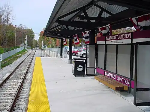 A high-level railway platform next to a single track