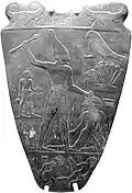 Narmer Palette: a glyph above left-warrior, (similar to a fortification compound?)