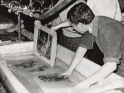 Responders to the flooding of the Arno in Florence washing a manuscript.