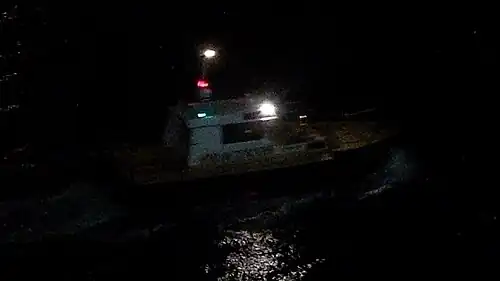 Pilot boat in Almería, Spain, showing the white-over-red night lighting