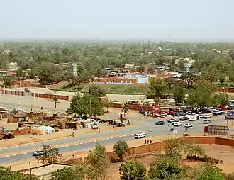 Niamey as seen from a multi-story building; several roads with cars are visible.