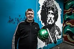Niaz with graffiti of Vazha-Pshavela