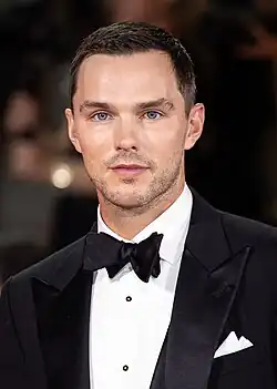 A young, Caucasian man with short, dark hair and facial stubble.