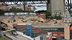 A demolition site with a lone brick building in its centre.