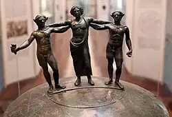 The bronze statuettes serving as a handle.