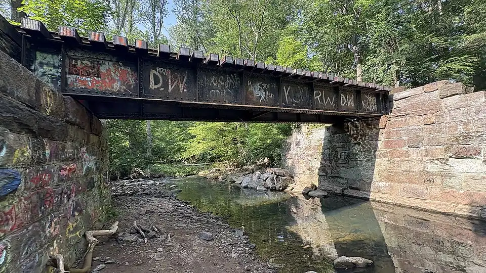 PRR style riveted plate girder bridge that crosses a portion of the Chester Creek. It intersects with Oakbourne Parks Yellow Trail.