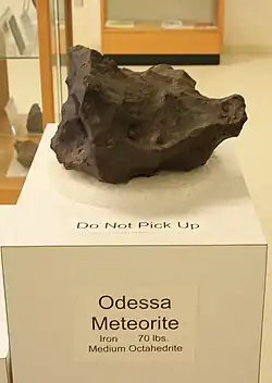 Photograph of a meteorite fragment on display