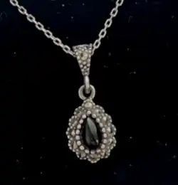 a teardrop shaped black stone pendant necklace