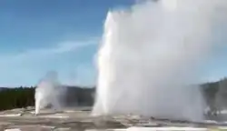 On rare occasions at the right point, Beehive (seen in the distance) will synchronize eruptions with the larger nearby Old Faithful